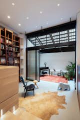 Office, Shelves, Chair, Rug Floor, and Bookcase A light well draws daylight into the piano room, infilling the back of the floor  plate with diffused light.   Photo 6 of 13 in A Steel Staircase Merges Two Units Into One in Tribeca
