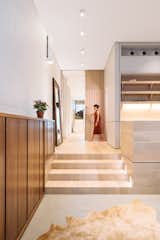 Staircase and Wood Tread A large, beautifully detailed wood pocket door allows the back of the first floor to be closed off from the rest of the floor, creating a private suite.   Photo 7 of 13 in A Steel Staircase Merges Two Units Into One in Tribeca