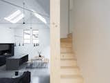 The wooden staircase winds its way between the living space and sleeping areas above. 
