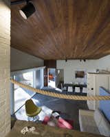 A stained cedar ceiling extends continuously over the living space.  The original rope railing remains intact.