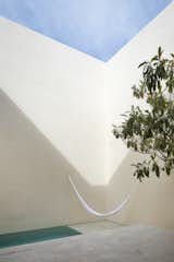 Outdoor, Stone Patio, Porch, Deck, Small Pools, Tubs, Shower, and Swimming Pools, Tubs, Shower During the day, light and shadows create abstract forms along the facades of the courtyard, providing different perspectives as the sun passes over.

  Photos from Muted Tones Mingle With Light and Shadows to Form a Quiet Mexican Oasis
