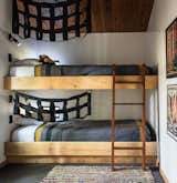 In the second bedroom, built-in bunk beds add a flair of fun, decorated with black netting. 