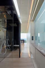Seamless transitions occur between spaces.  A frosted glass window allows daylight to fall into the bath space, while also providing privacy. 
