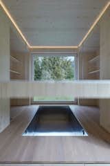 The movable bed rises up towards the ceiling to reveal a hidden hot tub below. 