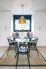 The deep blue color is extended into the dining space, and provides a colorful accent to the back wall of the seating area. 
