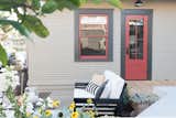 Doors, Wood, Exterior, and Swing Door Type From the outside, the new door is matched to the exterior color palette, appearing as an original piece of the home.  Photos from Budget Breakdown: A San Diego Couple Make Over Their Craftsman Bedroom For $29K