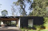 At the center of the home lies an open-air gathering space covered by the wood framed roof above. 