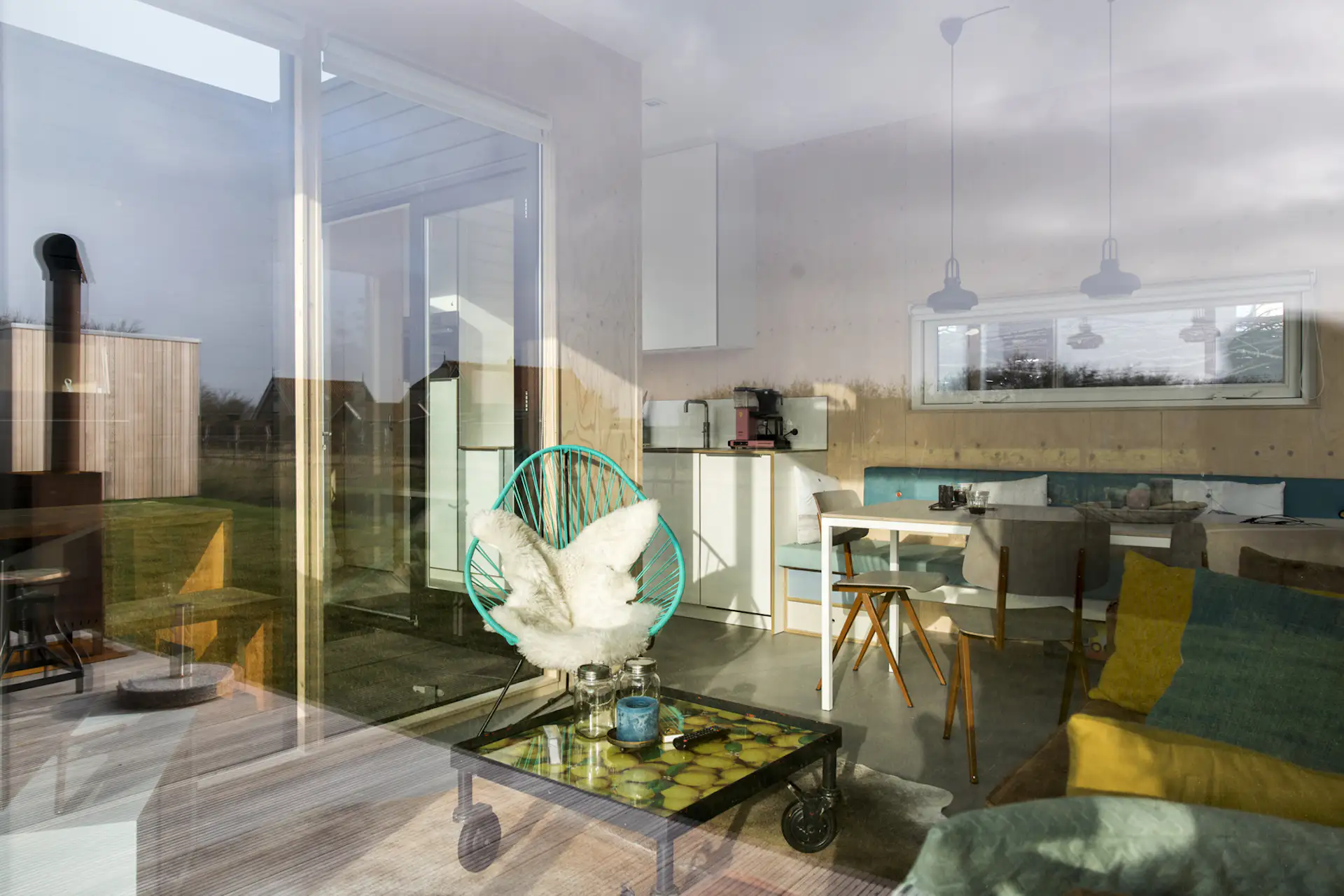 Expansive glazing creates a continuous visual connection between the interior living spaces and exterior patio.