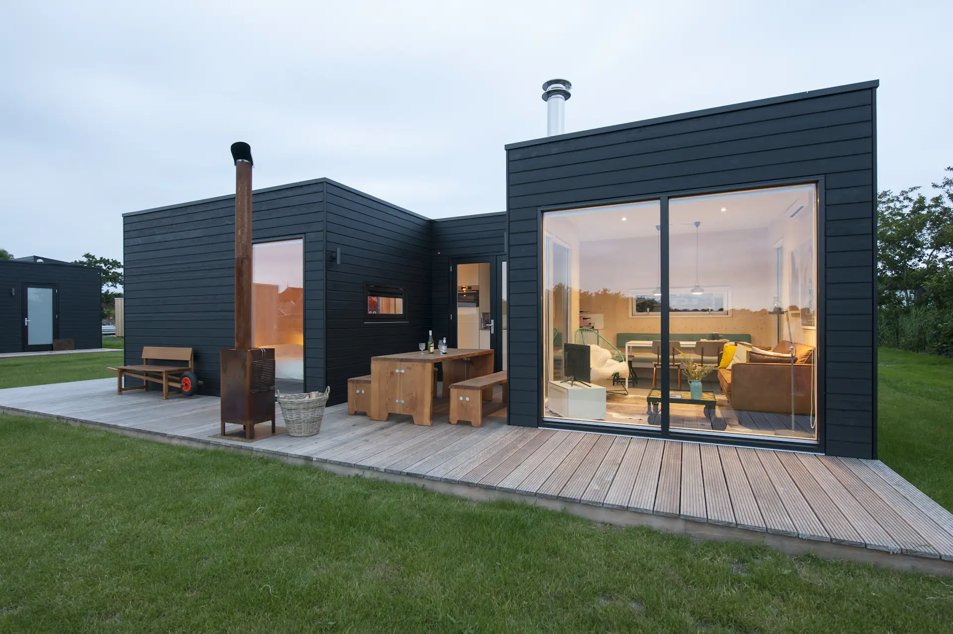 The simple massing consists of two blocks, which have been connected via an outdoor patio that wraps around the home. Here, outdoor spaces become one with the indoor elements.