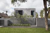 The exterior is composed of a rigid grid of Bluestone cladding that wraps the exterior facades.