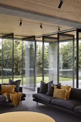Steel and glass pivot doors wrap the exterior of the living spaces providing a seamless connection between indoor and outdoor living. 