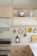 Open wooden shelving serve as an idyllic spot to display special kitchen gadgets and trinkets. 