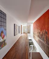 Hallway and Medium Hardwood Floor The circulation spaces are the "arteries" of the home, spreading color and artwork throughout the property.

  Photo 7 of 23 in A Luminous, Eco-Friendly Abode Is Completed With its Own Modern Art Gallery from Artery House