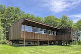 Exterior, House Building Type, Wood Siding Material, Cabin Building Type, Saltbox RoofLine, and Metal Roof Material Built on stilts, the dwelling appears to float gently on top of the landscape.   Photos from Rufus Stillman Cottage