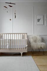 Scandinavian-inspired furnishings and a midcentury modern mobile create a stylish kid's room.
