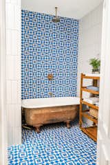 Colorful, patterned tile provides the perfect backdrop for the revamped clawfoot tub. Stewart-Schafer added new plumbing fixtures to make the tub double as a shower.