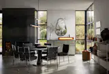 A  rolled steel fireplace lies between the kitchen and dining space. 