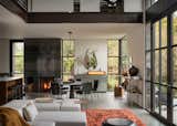 A steel fireplace lies between the dining space and open kitchen. 
