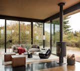 The cozy sitting area is an ideal writer's retreat.&nbsp; Full-height glazing provides unobstructed views to the outdoors.&nbsp; A rotatable fireplace allows the warmth to be enjoyed from either the inside or outside.