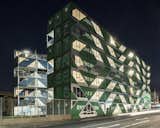 Large cuts in the outer walls of the shipping containers create a geometric pattern of glazed openings.  At night, the openings create a patterned facade that is both solid and transparent. 