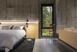 Abercorn Chalet bedroom with concrete walls and plywood accents