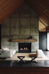 Concrete masses break up the grand interior spaces, while providing some solidity to the light framework of the home.