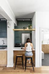 Dana Broza of Danka Design Studio was enchanted when she found this alluring bit of green in Tel Aviv's concrete jungle. Through unconventional space planning and creative design solutions, the designer completely transformed an outdated and dark midcentury apartment into a colorful and bright "Urban Jungle." In the kitchen, natural materials such as wood and rattan blend with pops of color. A simple overhang introduces additional seating at the counter.