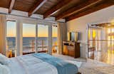 Bedroom, Bed, Carpet Floor, and Dresser The master suite includes two private decks, a fireplace, large closet, updated bath, and wood-beamed ceiling.  Photos from ‘Brady Bunch’ Actor Barry Williams Lists His Malibu Home For $6.4M