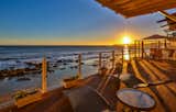 The oceanfront deck provides an idyllic spot for enjoying the ocean waves and watching the sunset. 