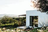 The home, located in a remote mountain field in the rugged north area of Ibiza, embraces its mountain views, Mediterranean climate, and Ibizan roots.