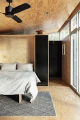 A queen-size Murphy bed folds down from this interior wall, transforming open living space into a bedroom.