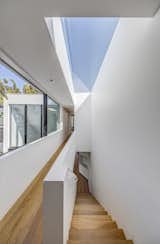 A large skylight mirrors the plan of the stairs, allowing light to fall into the corridors. 