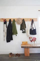 Natural wooden elements, like this custom-made coat rack and 15-foot-long wooden bench, outfit the home.
