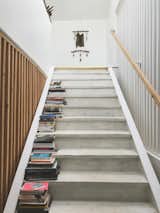 The white-washed wood staircase is framed by wooden slat walls on both sides.