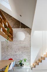 In the dining room and loft space, the original brick wall has been left exposed and raw. 