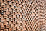 The steady rhythm and pattern of the brick creates a quilt-like facade. 