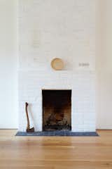 The original brick fireplace stands as a reminder of the home’s history.