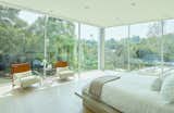 With floor-to-ceiling glass, the master bedroom has uninterrupted views of the surrounding vistas and rolling hills.