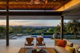 On the interior, a wooden ceiling floats gently above the concrete roof slab, providing additional space for ventilation and cooling.  Views from the main living spaces look onto the terraced yards and expansive views of rolling hills and farmland. 