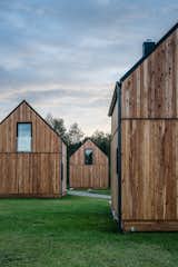 The simple structures are a modern play on the traditional cabin with wood-clad exteriors and gabled roofs.