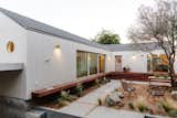 The original 1,000-square-foot house (where the open living, dining, and kitchen area is mostly located) abuts the new, 1,000-square-foot addition in an "T" configuration to make the best use of the site.