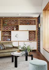 A recycled brick wall acts as the perfect backdrop to a custom media cabinet designed and built by Lisa Breeze.