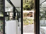 The bathroom was kept separate from the cabin to mimic the experience of camping, further immersing visitors in nature. The rustic cabin contrasts with the sleek, minimal bathroom retreat.