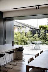 The indoor living spaces open onto a private garden retreat. Materials continue from inside to outside, further blurring the boundary between the two areas. 