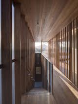 Inside, wood adds softness, texture, and warmth while allowing light to filter through.&nbsp; At the stair and master bedroom loft above, timber is used as an architectural screening material which provides some partition between spaces.&nbsp;