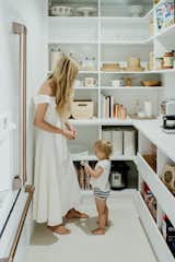 With the help of California Closets, the homeowners maximized every square inch of space with shelving, drawers, and a countertop area for placement of various small appliances like a microwave, coffee maker, and tea kettle. 