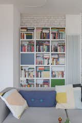 White walls serve as a backdrop for bold pops of color provided by furnishings, accessories, and books.