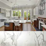 This stunning kitchen design combines modern and classic design elements.

What better way to seamlessly blend these elements than with timeless Calacatta marble? Calacatta marble is featured in the countertops, backsplash and fireplace cladding.

Take a tour of our extensive marble collection online or in our showrooms: http://www.egmcorp.com/stone-types/marble
