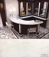 This bar design accentuates the Pure White Onyx countertops by contrasting with dark wood details.

Onyx is translucent and can be lit from behind or beneath to showcase its crystalline beauty. In this case, the stone has a super polished to add a brilliant reflective shine.

Find out more here: http://www.egmcorp.com/onyx/white-onyx-super