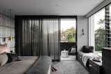 Bedroom, Bed, Pendant Lighting, Bench, Storage, Chair, and Carpet Floor  Photo 7 of 9 in The Rose Bay House by Prebuilt
